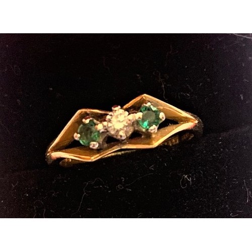 129 - An 18 carat yellow gold, Diamond and Emerald ring, size M.