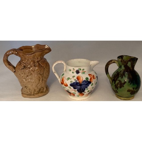 7 - Miniature saltglazed Bacchus jug 8 cm high, together with a miniature Swansea jug, 6 cm high and ano... 