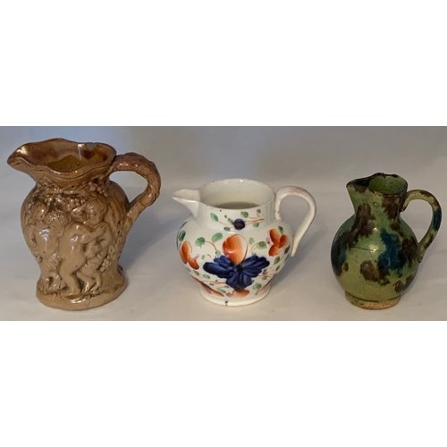 7 - Miniature saltglazed Bacchus jug 8 cm high, together with a miniature Swansea jug, 6 cm high and ano... 