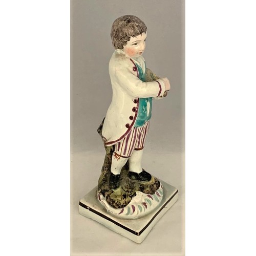 9 - Pottery figure, Staffordshire, early 19th century, with painted decoration, depicting a boy with bir... 