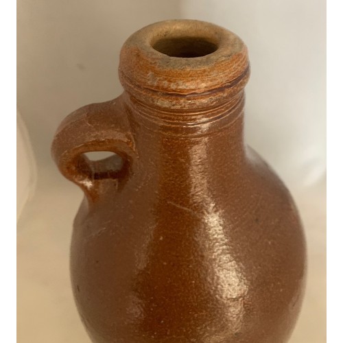 14 - German early 18th century salt glazed stoneware wine flagon, of ovoid form with ring handle, 26 cm h... 