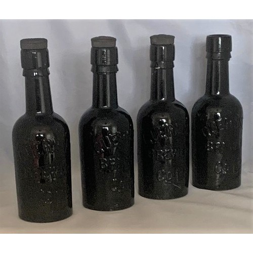 63 - Collection of four black glass Beer bottles,  'Guernsey Brewery Co Ltd.' (4).