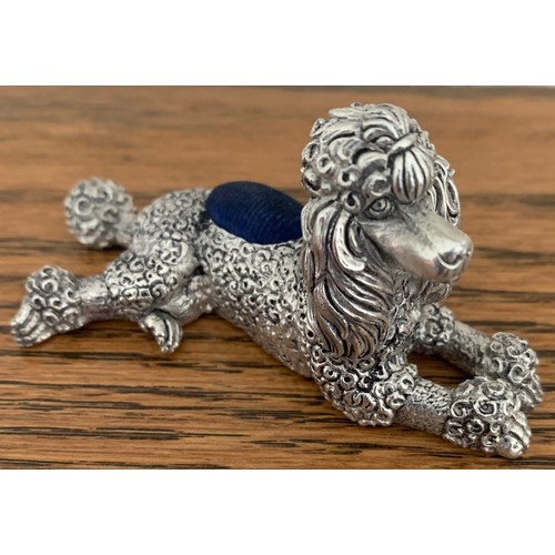 55 - 800 silver pin cushion, in the form of a seated poodle, total weight 70 gms 8 cm long.