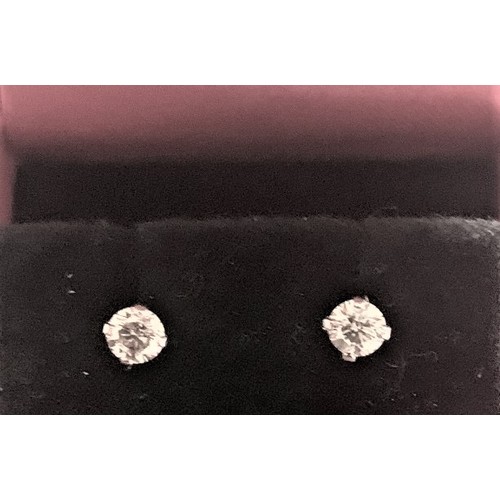 66 - Pair of 14 carat white gold diamond stud Earrings, 50 points total weight.