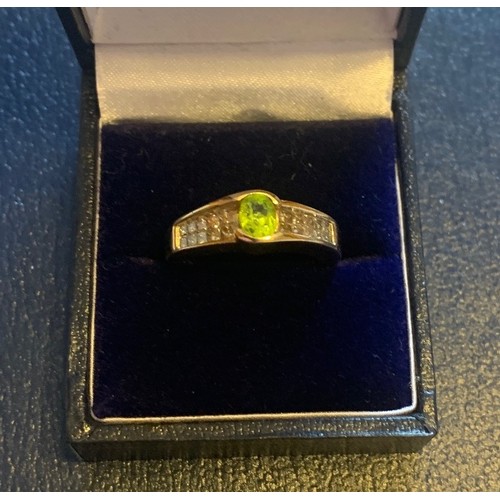 69 - A 14 carat yellow gold peridot and diamond ring