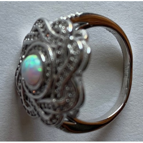 111 - Silver and cubic zirconia ring with central opal panel.