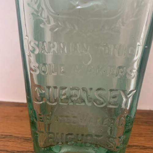 103 - Guernsey clear glass bottle with Coat of Arms, 'ST Sarnian Tonic Sole Makers Guernsey Aerated Water ... 