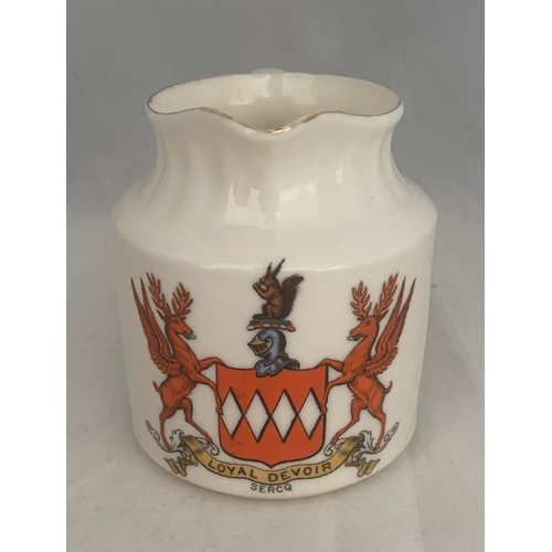 103 - W.H.Goss, a milk jug with the de Carteret Coat of Arms to front, the base with Goss mark, 9 cm high.