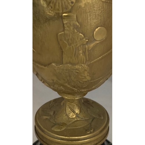 51 - A gilt brass Grand Tour style chalice, 19th century, decorated with seven figures and a lion in high... 