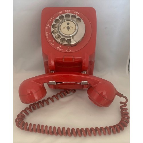 60 - An original vintage Ericsson red rotary dial wall mounted telephone.