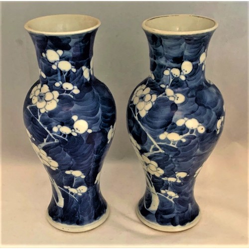 61 - Pair of Chinese blue and white Prunus decorated vases, 19th century, of baluster form, the bases wit... 