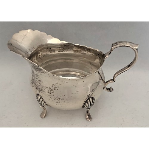 73 - Silver sauce boat, London 1907 by William Hutton & Sons Ltd, with wavy edged rim and scroll handle, ... 