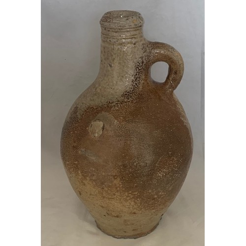 24 - 17th century salt glazed flagon with ring handle, some chips to base, a/f 24 cm high.