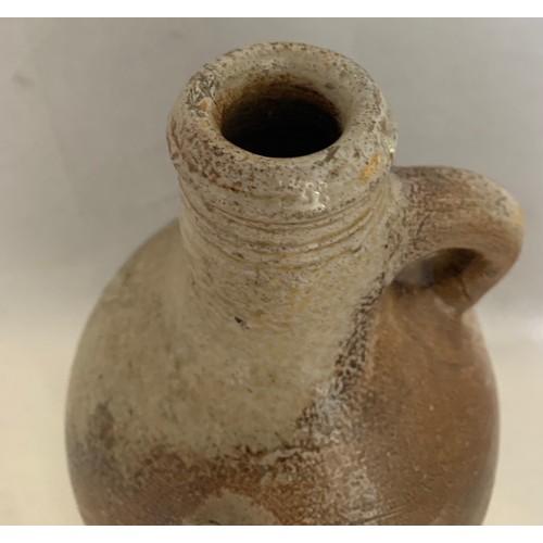 24 - 17th century salt glazed flagon with ring handle, some chips to base, a/f 24 cm high.