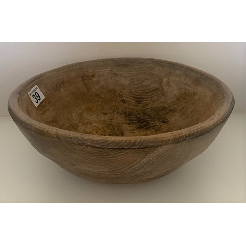 39 - A vintage sycamore dairy bowl, late 19th century, the exterior with incised banding, recently restor... 