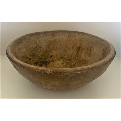 39 - A vintage sycamore dairy bowl, late 19th century, the exterior with incised banding, recently restor... 