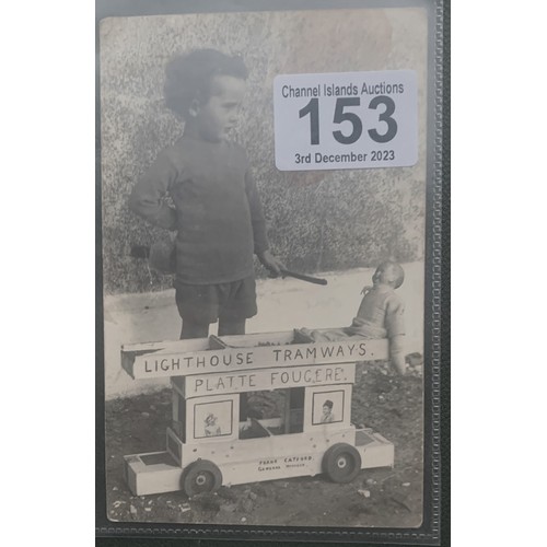 153 - * Guernsey interest - RP postcard, young boy playing with a Platte Fougere Lighthouse Tramways toy T... 