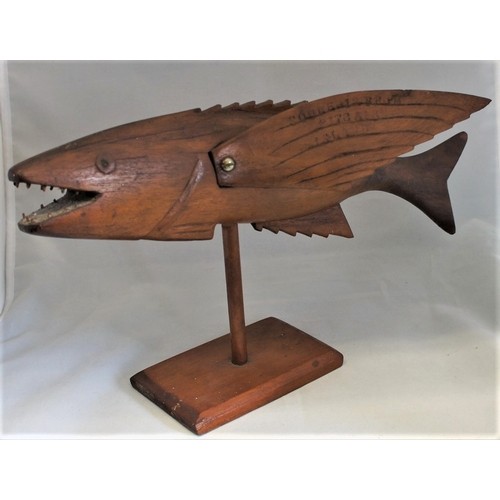 25 - A carved wooden Pitcairn Island Flying Fish on stand, early 20th century, inscribed 'Made by Wallace... 