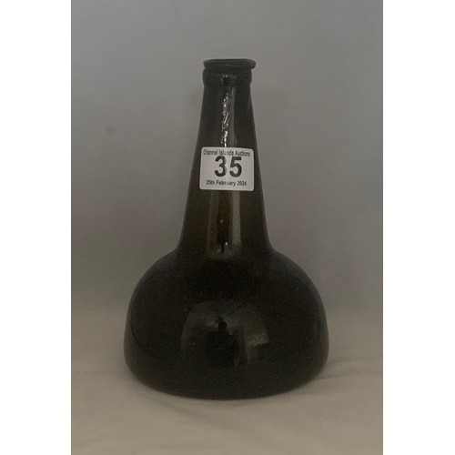 35 - Black glass mallet-shaped  or Transitional wine bottle, 18th century, with applied neck ring and dee... 