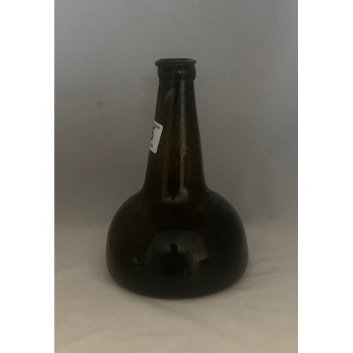 35 - Black glass mallet-shaped  or Transitional wine bottle, 18th century, with applied neck ring and dee... 