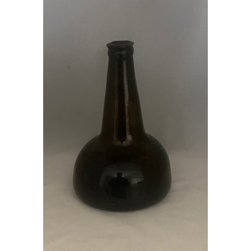 35 - Black glass mallet-shaped  or Transitional wine bottle, 18th century, with applied neck ring and dee... 