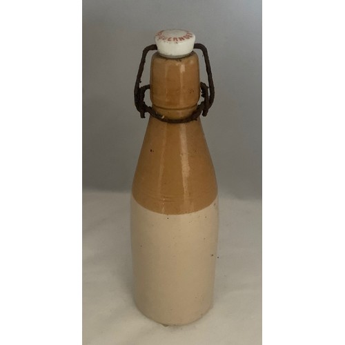 42 - Stoneware two tone bottle with black transfer, 'E. & W. Guppy Stone Ginger Beer Guernsey' with metal... 