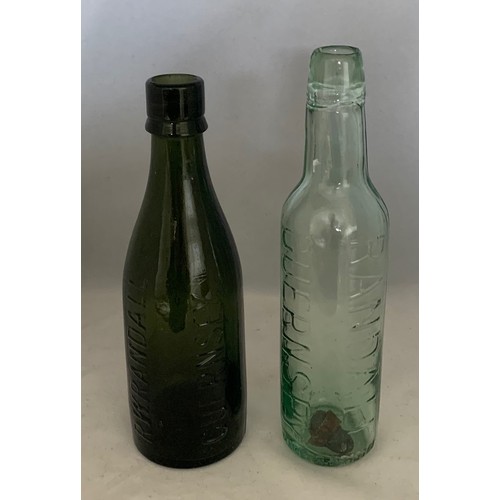 49 - Black glass beer bottle, 'R.W.Randall Guernsey' 23.5cm high, together with a clear glass bottle 'Ran... 