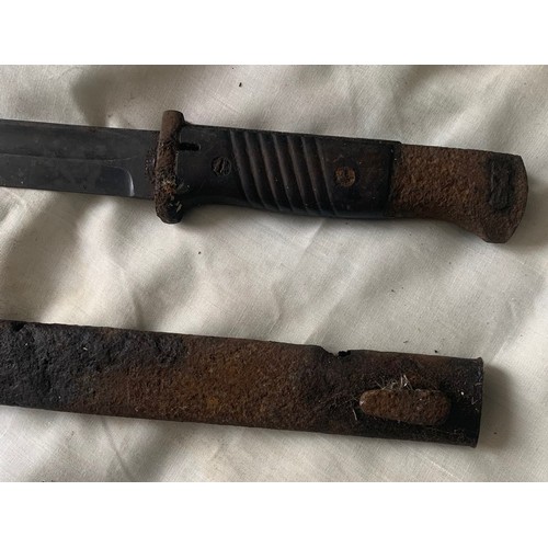 77 - A vintage Military Sabre or Cavalry Sword,  in poor condition, together with a Bayonet, both as foun... 