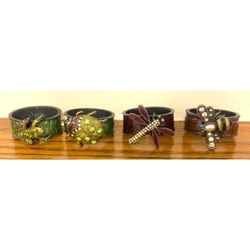 112 - Jay Strongwater, American novelty napkin ring in the form of a green frog, together with three other... 