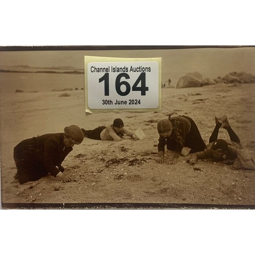 164 - Real photographic postcard, finding sea shells on Shell Beach Herm 1922.