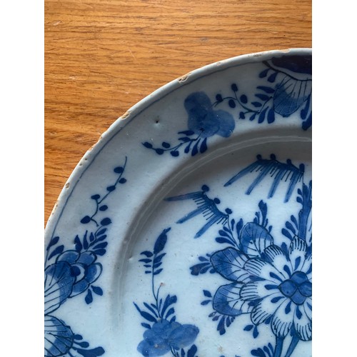 50 - A Chinese export blue and white plate, early 19th century, with central flower and decorated floral ... 