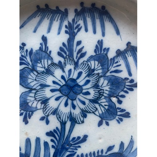 50 - A Chinese export blue and white plate, early 19th century, with central flower and decorated floral ... 