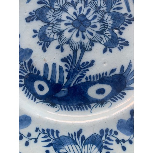 50 - A Chinese export blue and white plate, early 19th century, with central flower and decorated floral ... 