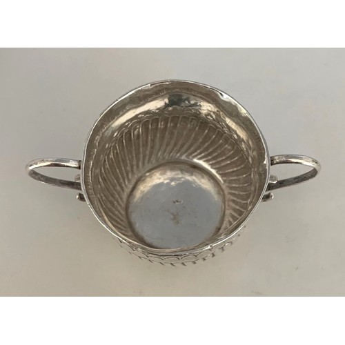 11 - A silver miniature  Porringer  by James Clare London circa 1718, with punched flower head and fluted... 