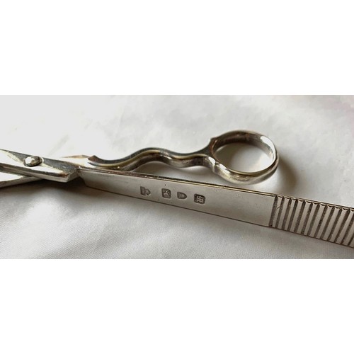 14 - A pair of silver scissor action asparagus tongs by Thomas Henning London 1763, with loop handles,  w... 