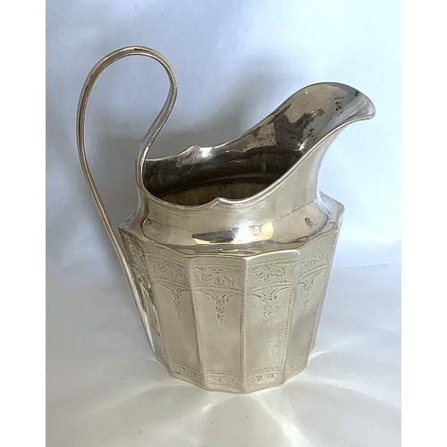 15 - A white metal milk jug, of dodecagon form with bright cut decoration and reeded loop handle, maker J... 