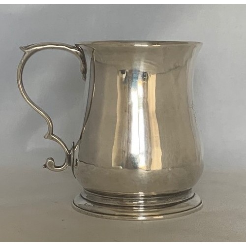 34 - A silver tankard, early 19th century, with indistinct hallmarks, of plain baluster form with acanthu... 