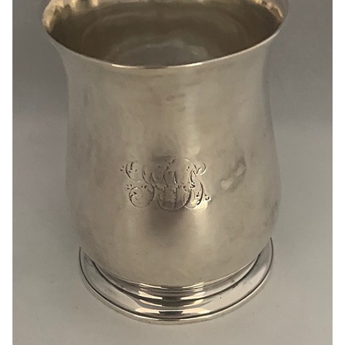 34 - A silver tankard, early 19th century, with indistinct hallmarks, of plain baluster form with acanthu... 