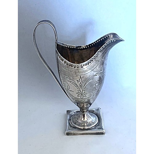 74 - A silver cream jug by Peter, Ann and William Bateman London 1804, of helmet form with reeded loop ha... 