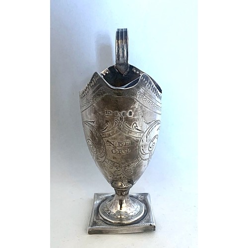 74 - A silver cream jug by Peter, Ann and William Bateman London 1804, of helmet form with reeded loop ha... 