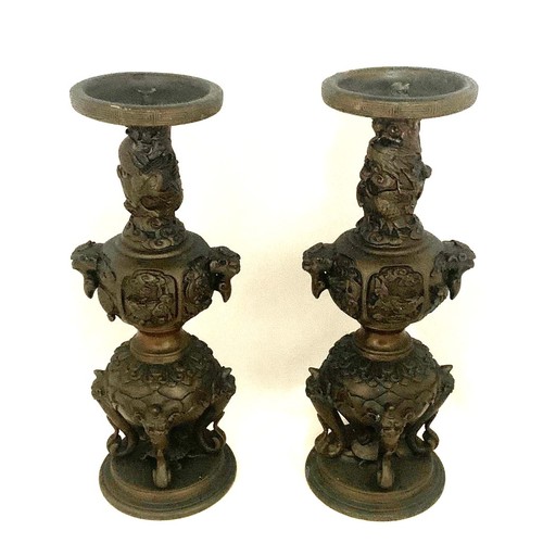 13 - Pair of Chinese bronze candle sticks, late 19th century, with dragon mask handles, elephant trunks, ... 