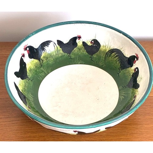 28 - Wemyss Ware pottery bowl of large proportions, decorated with twenty-three black painted Cockerels a... 
