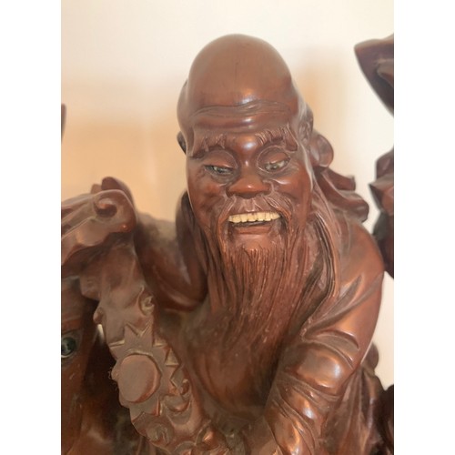 25 - Chinese carved hardwood group, Shou Lao riding a Stag whilst holding a carved staff, with attendant ... 