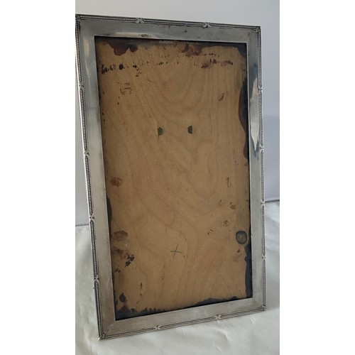 22 - Silver easel back photograph frame, Birmingham 1925 by Charles Edwin Turner, the inner aperture 24 x... 
