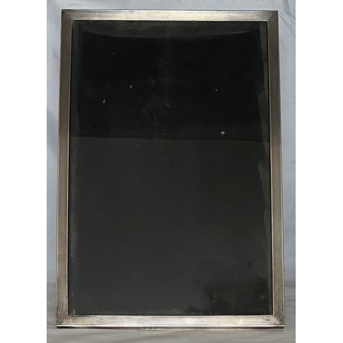 23 - Silver easel back photograph frame, Birmingham 1954 by Sanders & Mackenzie, the inner aperture 28.5c... 