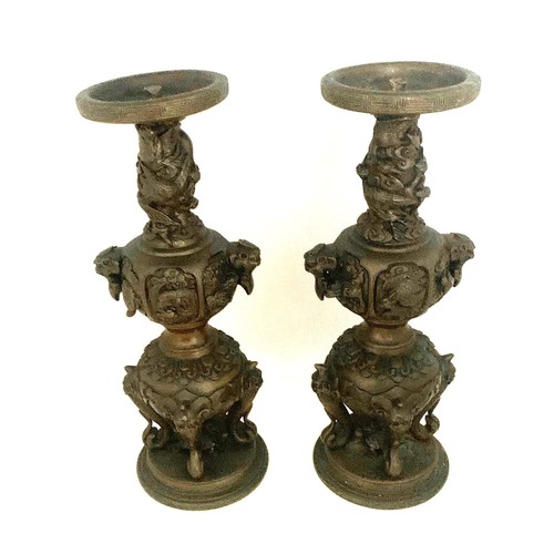 53 - Pair of Chinese bronze candle sticks, late 19th century, with dragon mask handles, elephant trunks, ... 