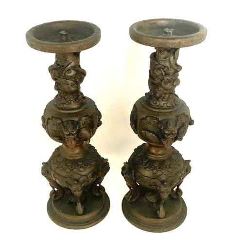 53 - Pair of Chinese bronze candle sticks, late 19th century, with dragon mask handles, elephant trunks, ... 