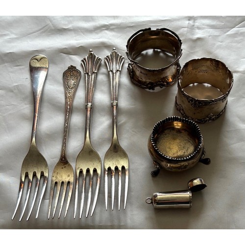 28 - Two silver napkin rings, silver cauldron salt, silver tubular small pill box, four silver forks, thr... 