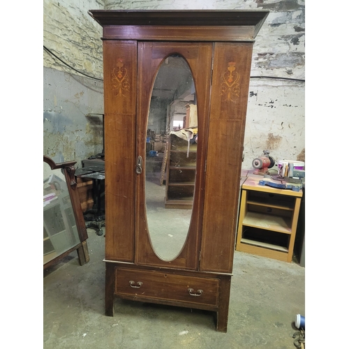 11 - AN EDWARDIAN SINGLE DOOR WARDROBE WOTH FEATHER INLAY, OVAL MIRRORED DOOR,
AND SINGLE DRAWER. FULL SE... 