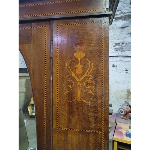 11 - AN EDWARDIAN SINGLE DOOR WARDROBE WOTH FEATHER INLAY, OVAL MIRRORED DOOR,
AND SINGLE DRAWER. FULL SE... 